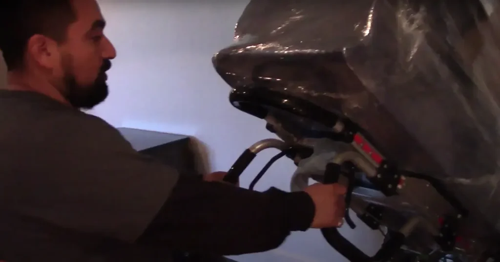 Local Movers 13 Mover guiding a shrink-wrapped piece of equipment indoors